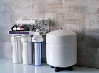 Household filtration system. Water treatment concept. Use of water filters at home. Glass of clean...