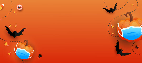 Happy Halloween trend horizontal background. trick or treat pumpkin with protective medical mask, bats, eye, colored candy on orange gradient background