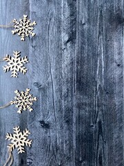Fototapeta premium Snowflakes on wood background