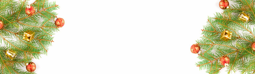 Christmas background, fresh fir tree branches with red baubles and golden gifts isolated on white, horizontal new year web banner