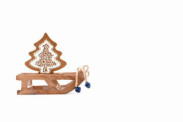 A wooden zero waste small toy sleigh with wooden Christmas tree, New year is coming. Reusable sustainable recycled decor. Eco friendly new year. Flat lay Merry Christmas car