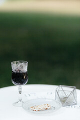 Glass of red wine on the white tablecloth with the place for your text. Background
