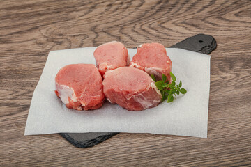 Raw pork medallion served rosemary