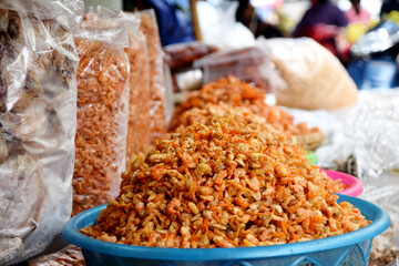 Big pile of raw dried shrimps for sale at a street food vendor on the streets of Hanoi, Vietnam
