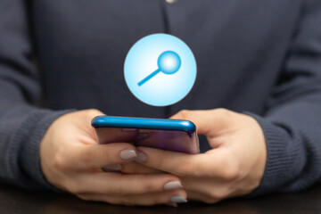 Searching Browsing Internet Data Information on phone, female hands with smartphone and magnifying glass icon