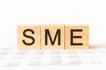 Word sme. Wooden small cubes with letters isolated on white background with copy space available.Business Concept image.