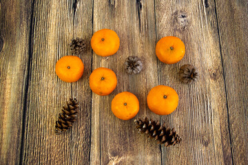 Tangerines and cones isolated on the wood background New year and Christmas concept