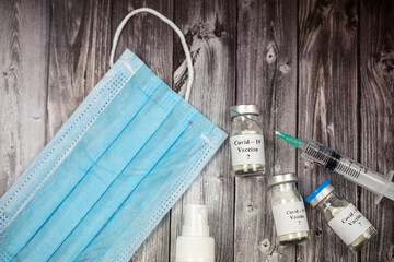 Coronavirus virus concept. Infection vaccine, face mask and syringes	
