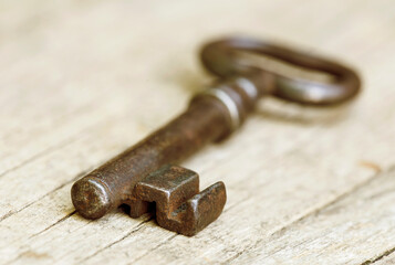 Real estate, rent, buy or sell home concept, vintage old key on a wooden background
