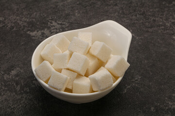 Refined white sugar cubs in the bowl