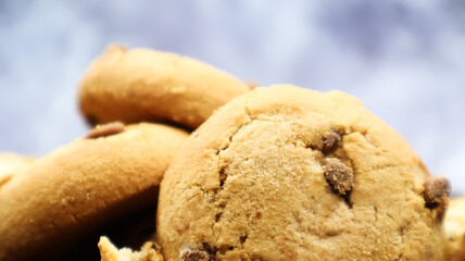 Soft, freshly baked chocolate chip cookies on a gray marble kitchen countertop. American traditional sweet pastry pastry, delicious homemade dessert. Culinary background. Close-up