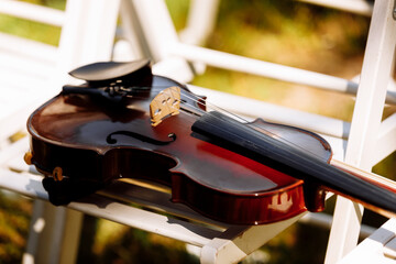 Beautiful violin on a white chair. selective focus.