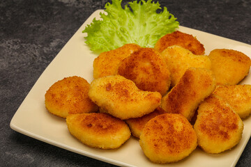 Fried chicken nuggets served salad leaves