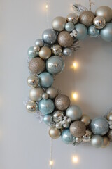 Christmas wreath of Christmas toys on a white background with lights