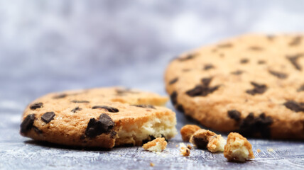 One soft, freshly baked chocolate chip cookie on a gray marble kitchen countertop. American traditional dessert. Delicious sweet food. Homemade baking concept for the holiday. Culinary background