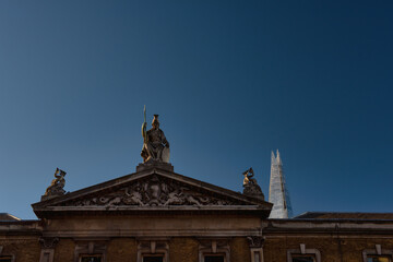 Fototapeta na wymiar Decorative pediment of the Old Billingsgate building, London, England 
