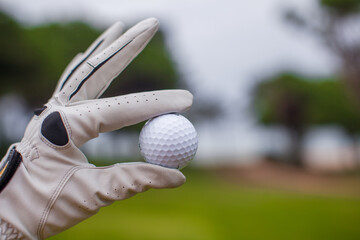 Golf player man holding golf-ball in his hand