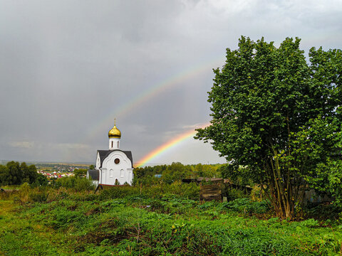 Landscape with the image of church and rainbow