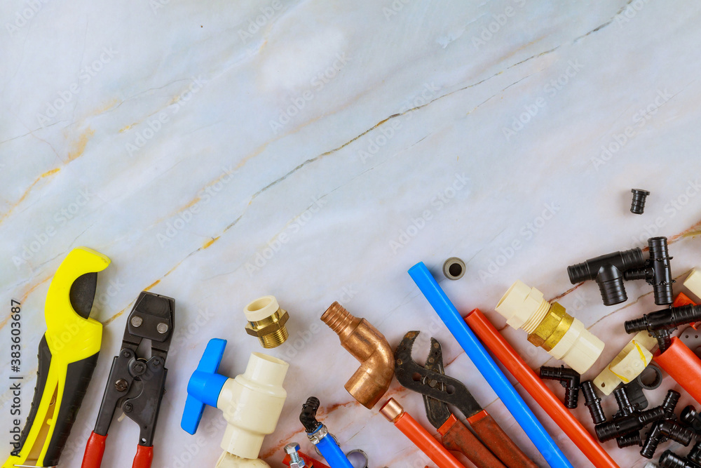 Wall mural Plumbing tools, pipe fittings on a home improvement plumbing materials including copper pipe, elbow joint, wrench and spanner.