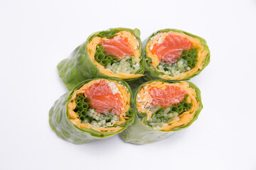 Rice red fish rolls with cabbage leaves isolated on table