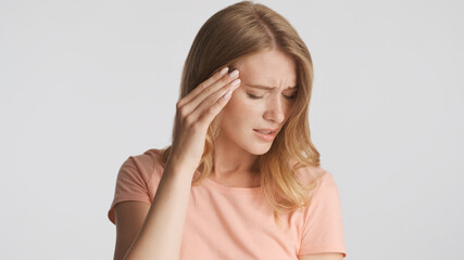 Young upset woman keep hand on temple feeling headache isolated