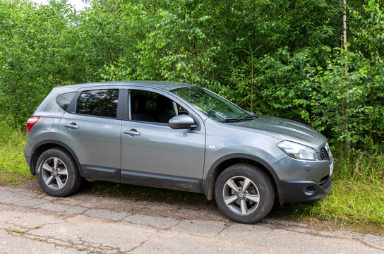 Nissan Qashqai On The Background Of Green Trees