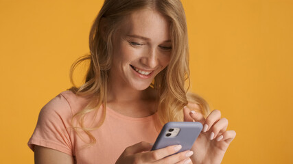 Close up pretty blond girl using smartphone enjoy online communi