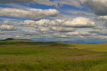 Montana - Little Farm on the Prairie under the Clouds by Highway 89 to Browning