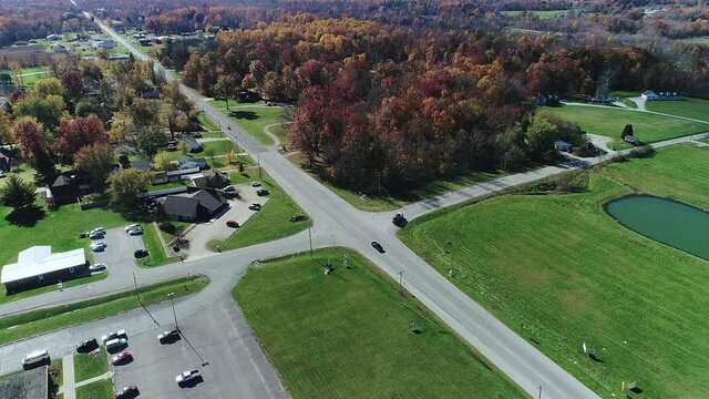 A crossroads in the heartland is surrounded by fall trees