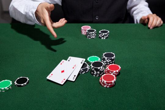Poker player throwing down a pair of aces