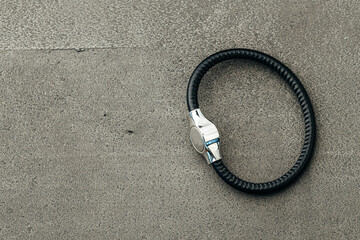 Metal key pendant on dark concrete background