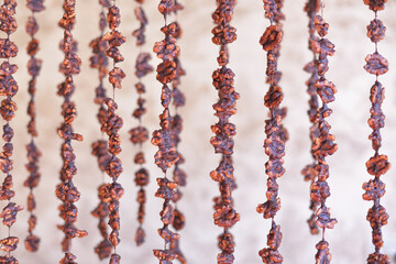 The nuts are strung on the thread to prepare the Caucasian sweetness churchkhela. Walnut on a string.  Churchkhela. Walnut sujuk.