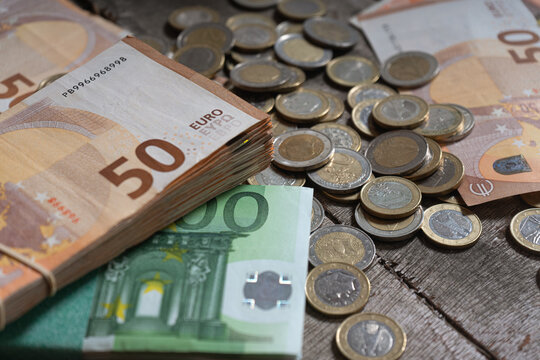 Isolated image of euro coins and banknotes in many European countries on wooden background