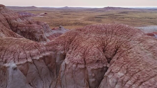 Flying backwards revealing red desert mars like landscape in Wyoming moving low over hilltops.