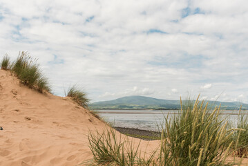 Looking through the dunes at Sandscale Haws, Cumbria, England towards Black Combe fell across the estuary.