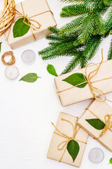Obraz na płótnie Canvas Zero waste gift concept with craft boxes and evergreen branches