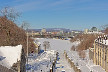 Locks of Rideau canal in winter, covered in snow on a sunny winter day with clear blue sky. Ottawa, capital city of Canada
