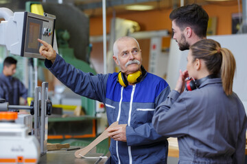 team of engineers having discussion in factory