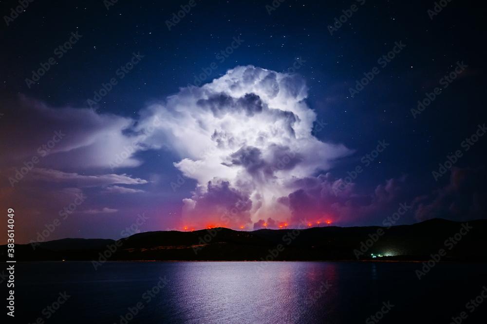 Canvas Prints An ominous storm clouds are highlighted by lightning.