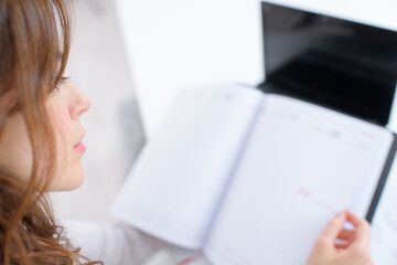 a lady looking in diary