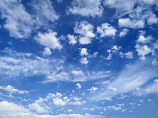 Naklejka na ściany i meble Beautiful blue sky with small white cumulus and large cirrus clouds as natural background