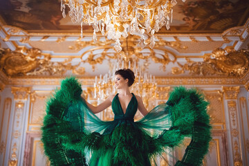 Portrait of a beautiful young girl in a Haute couture green dress.
