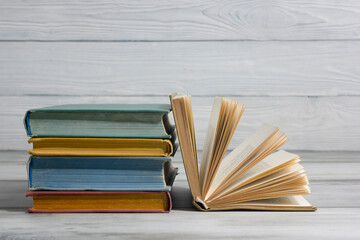 Open book, hardback books on wooden table. Back to school. Copy space