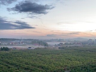 Beautiful panoramic picture of foggy evening sunset in autumn