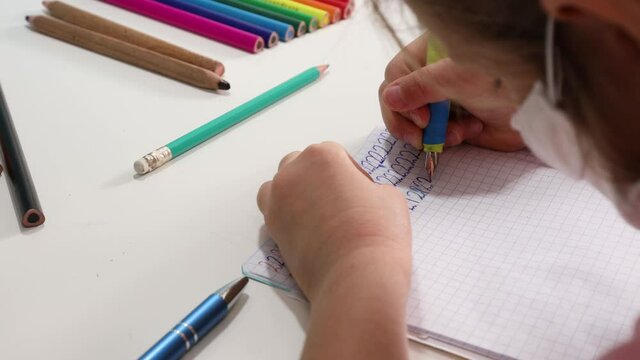 Little Girl is learning to write numbers.