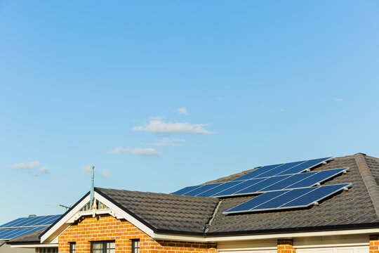Solar panels covering tiled roof of townhouse
