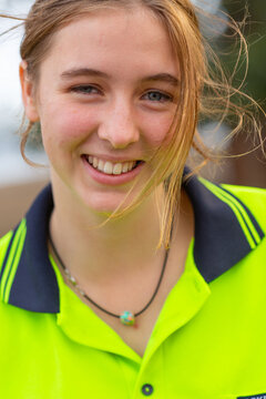 Young Woman With Messy Hair Wearing Hi Vis Smiling At Camera