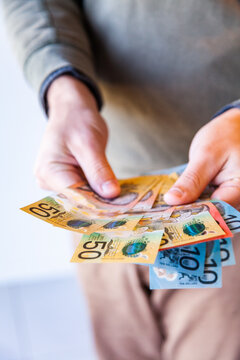 Vertical image of man with australian currency notes in hands