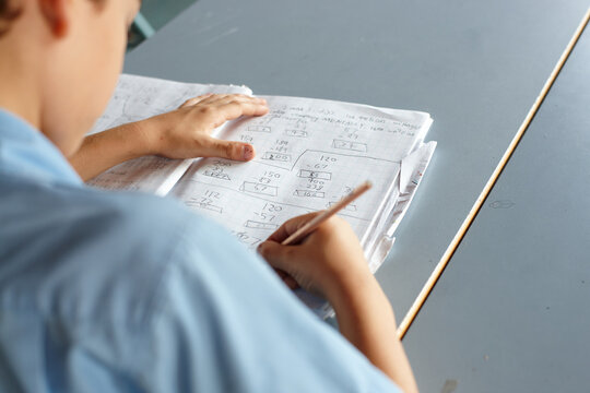 Primary school student in classroom working on homework
