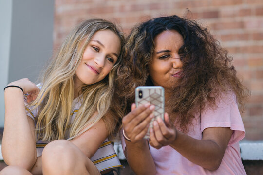 two young women making selfies